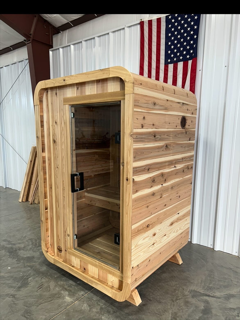 One-person Blazin Pod Mini cedar sauna with glass door, front angle, in the Idaho Falls shop