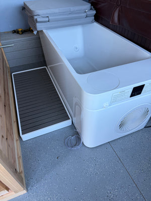 Empty cold plunge tub interior with jets and folded insulated cover