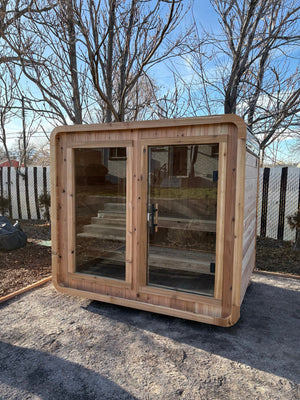 Finished Blazin Cube Sugi cedar sauna on a leveled gravel pad after professional assembly