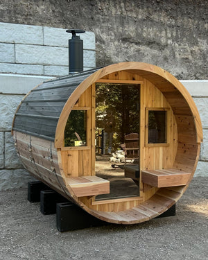 XL Blazin Barrel sauna with a covered porch and chimney at a customer home in Downey, Idaho
