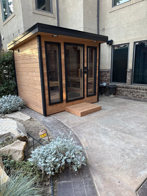 Timberline Lux cedar sauna seen from the side on a curved concrete path