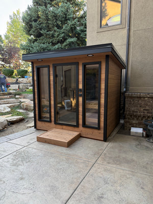 Timberline Lux on a backyard patio with stone landscaping behind it