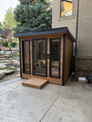 Timberline Lux glass front with a cedar step and evergreen trees behind