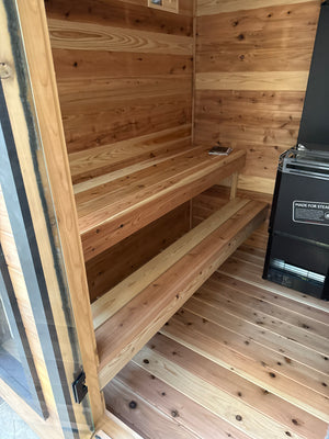 Timberline Lux interior with two-level cedar benches and a black electric heater