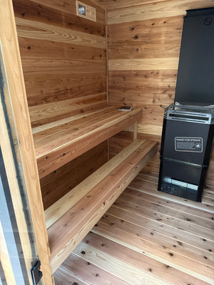 Cedar benches, wood floor and black heater inside the Timberline Lux
